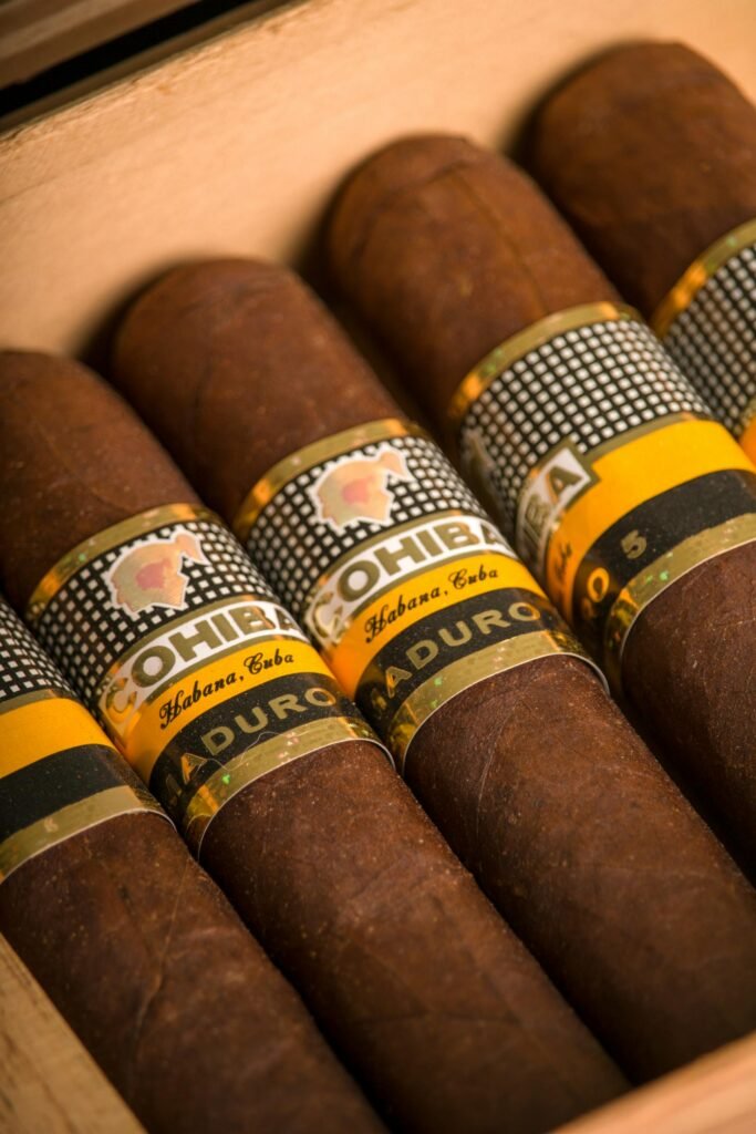 A selection of premium cigars showing different brands, wrapper colors, sizes, and shapes